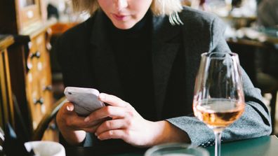 Woman on phone in restaurant