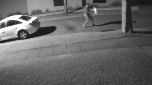 The man is seen running from a white Holden Cruze ... (Supplied)