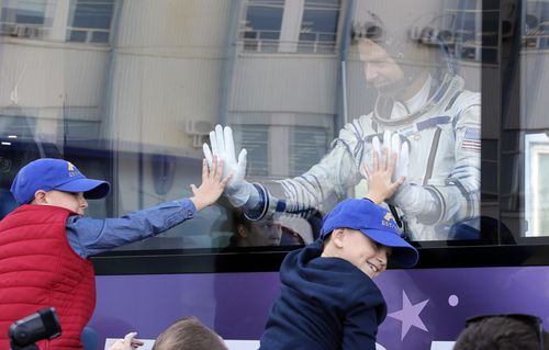 Hague waves to his sons as he boards the bus to the launch site.