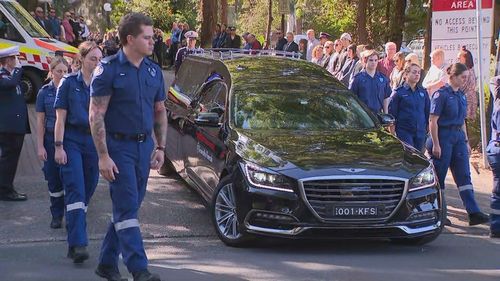 As Tougher's coffin made its way to its final resting place family, friends, dignitaries and paramedics formed a guard of honour.