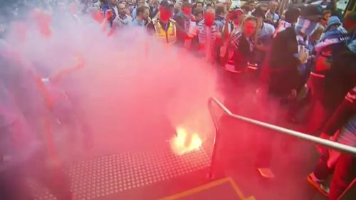 Anyone who lets a flare off inside a stadium is issued with a five-year ban. (9NEWS)