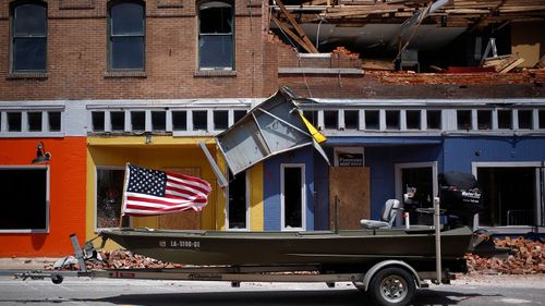 A US flag flies on a boat parked in front of a damaged building after Hurricane Laura made landfall in Lake Charles, Louisiana on Aug. 27.