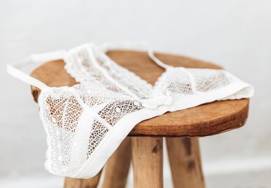 delicate lace bra on a wood  stool