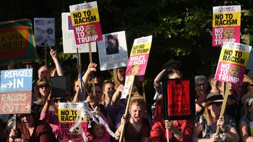 Protestors pictured outside the entrance to Blenheim Palace ahead of Mr Trump's arrival. Picture: PA