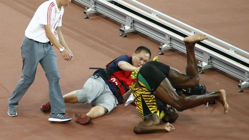 Bolt managed a backward somersault after the tumble. (AAP)