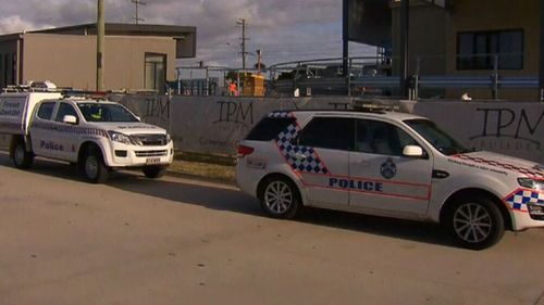 Police believe strong winds may have played a role in the collapse of the wall that left a worker with serious injuries to his head.