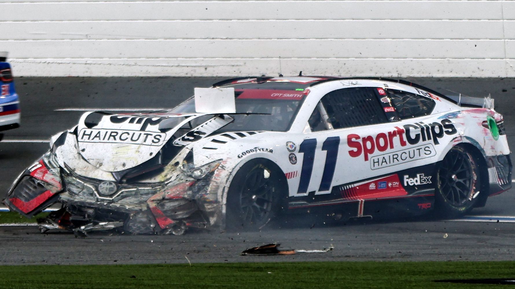 Denny Hamlin, driver of the No.11 Toyota, lays idle on the race track after being wrecked by Chase Elliott.