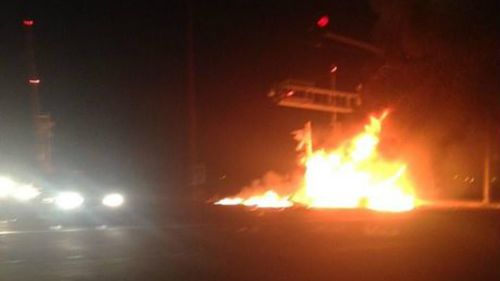 A local captured this image of the flaming truck in the moments after the crash. (Twitter/@LisaAnneColley)