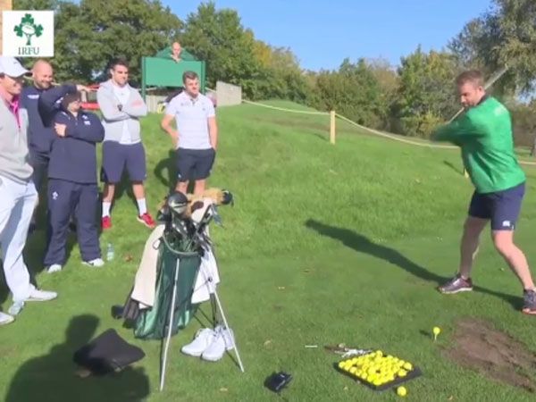 Ireland rugby star Luke Fitzgerald tries to tee off as Rory McIlroy and his teammates watch on. (Supplied)