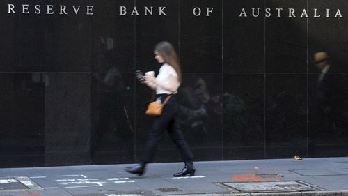 A woman walks past the outside of the Reserve Bank in Sydney, Australia.