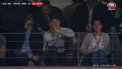 Prince Harry enjoys AFL match as world waits for glimpse of royal baby