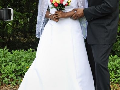 Female wedding photographer with couple