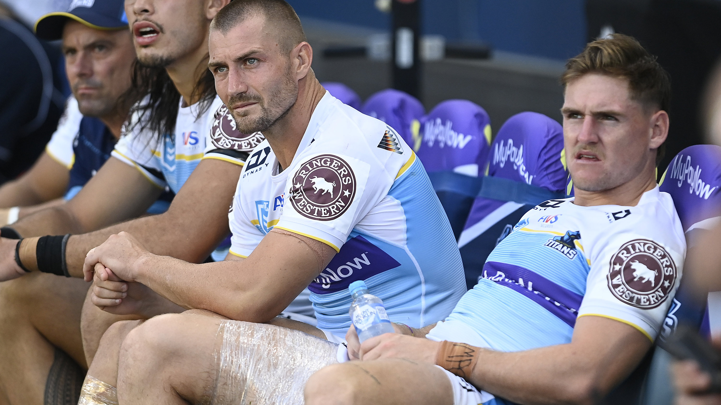 AJ Brimson and Kieran Foran sit on the bench after being injured during the round four NRL match between North Queensland Cowboys and Gold Coast Titans.
