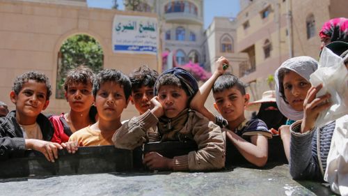 Yemeni children wait for food rations. (AFP)