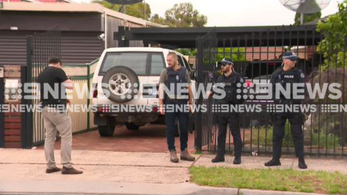 Two men were spoken to in the front yard of the home before being led away. 