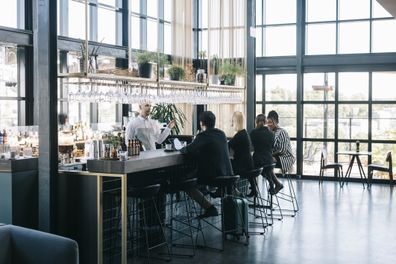 Group of people at the airport business class bar