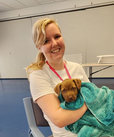 Caitlin Kelly cuddles up to a rescue puppy.