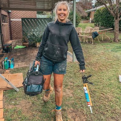 Aimee Stanton carrying her tools as a lady tradie.