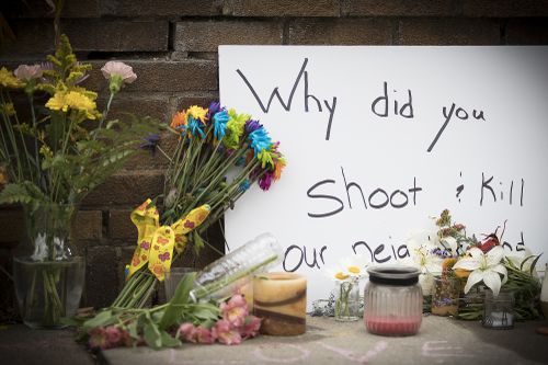 A placard outside Justine's house sums up the incomprehension of the locals to the shooting. Picture: AAP