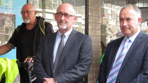 Stewart issued an apology outside the paper's Dunedin office today and was met with almost 50 people carrying signs that read "Samoan lives matter".