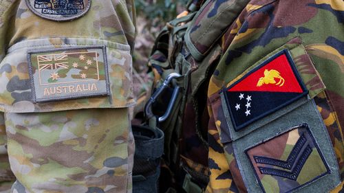 The emblem of an Australian Army soldier, left, and a Papua New Guinea Defence Force soldier during an exercise at Talisman Sabre in Townsville, Australia, on July 21, 2025.