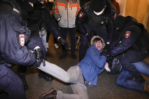 Police officers detain demonstrators in St. Petersburg, Russia, Thursday, Feb. 24, 2022. Hundreds of people gathered in Moscow and St.Petersburg on Thursday, protesting against Russia's attack on Ukraine. Many of the demonstrators were detained. Similar protests took place in other Russian cities, and activists were also arrested. (AP Photo/Dmitri Lovetsky)