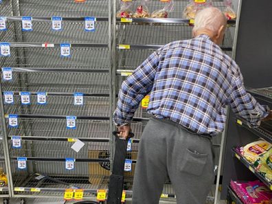 Man at IGA in Australia looking for bread.