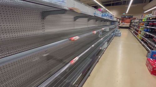 There are empty shelves at local supermarkets as people stock up on supplies.