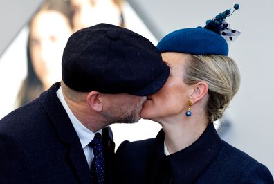 Mike Tindall and Zara Tindall kiss as they attend day 2 'Ladies Day' of the Cheltenham Festival at Cheltenham Racecourse on March 16, 2022 in Cheltenham, England