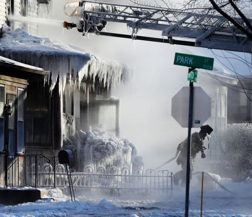 Firefighters at the scene of a house fire in St Paul, Minnesota.