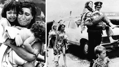 In one of the most iconic photos of Cyclone Tracy, Mariana Gatis holds her children in her arms. Right: A policeman carries an injured girl into the air terminal on December 27, 1974 at Darwin airport. (AAP)