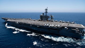 The aircraft carrier USS Theodore Roosevelt transits the Pacific Ocean in 2019. Theodore Roosevelt is conducting operations in the South China Sea.