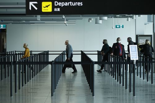 MELBOURNE, AUSTRALIA - NOVEMBER 23: People are seen at Melbourne Airport checking in for flights to New South Wales on November 23, 2020 in Melbourne, Australia. COVID-19 restrictions have relaxed further in Victoria as the state continues to record no new coronavirus cases. From Monday, Victorians no longer need to wear masks when outside at all times, with people only required to wear masks when indoors and on public transport, or in places outside where social distancing is not possible. Unde