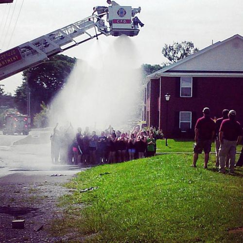 Firefighters drop water onto a group of Campbellsville University students before they suffer an electric shock during an ice bucket challenge. (Twitter/@JenKeeney)