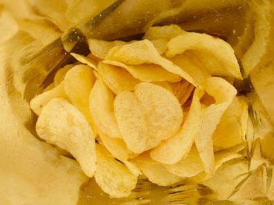 Crispy potato chips with salt inside foil bag package