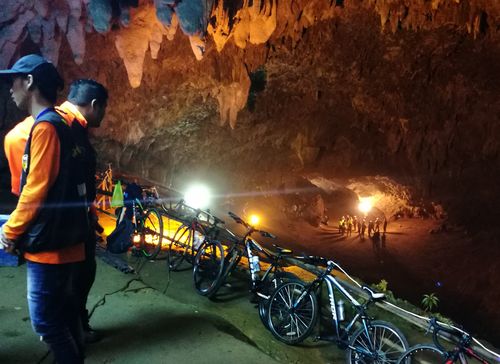 Thai rescue workers and park officials rest outside the Tham Luang Nang Non cave. Picture: AAP