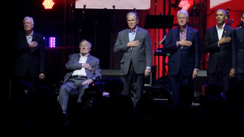 The ex-presidents were all smiles during the concert proceedings. (AP)