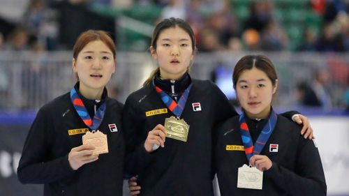 First place finisher Shim Suk-hee, center, second place finisher Kim Ji-yoo, right, and third place finisher Noh Do-hee celebrate after the women's 1500-meter finals at a World Cup short track speedskating event at the Utah Olympic Oval in Kearns, Utah. (AAP)