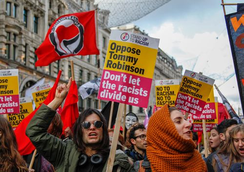 Marchers oppose Tommy Robinson in a demonstration three days before parliament is due to make the crucial vote on Theresa May's Brexit deal with the European Union. 