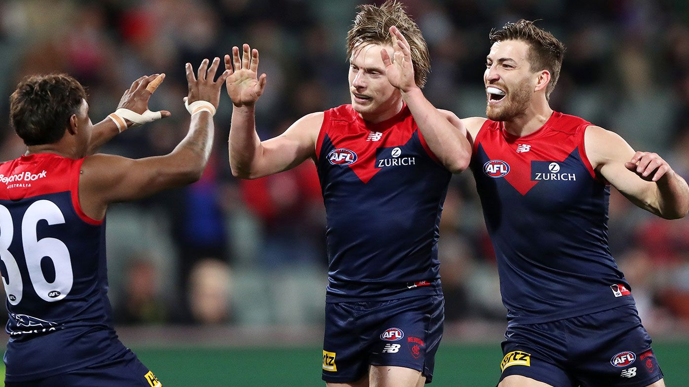 Charlie Spargo of the Demons celebrates a goal with Kysaiah Pickett and Jack Viney during the 2021 AFL First Qualifying Final match between the Melbourne Demons and the Brisbane Lions at Adelaide Oval on August 28, 2021 in Adelaide, Australia. (Photo by Sarah Reed/AFL Photos via Getty Images)