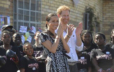 Meghan (left) and Prince Harry, (right), greet children and youths on a visit to the Nyanga Methodist Church in Cape Town, South Africa, Monday, Sept, 23, 2019 which houses a project where kids are taught about their rights, self-awareness and safety, and are provided self-defence classes and female empowerment training to young girls in the community.  