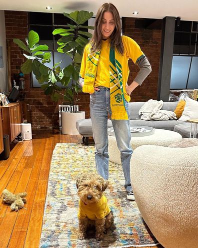 Rebecca Harding and Andy Lee watch the game at home with their dog dressed up for the occasion