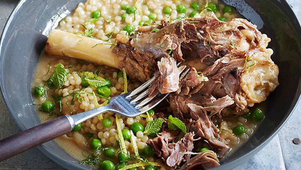Braised lamb shanks with pearl cous cous, peas and mint