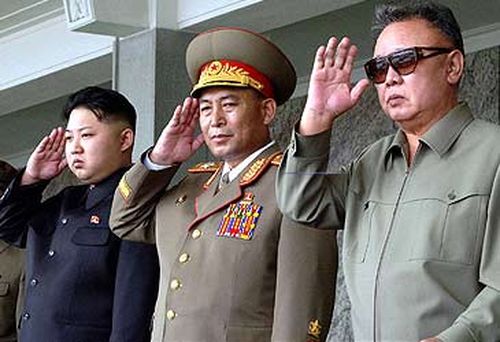 Kim Jong-un (left) an unnamed officer, and former leader Kim Jong-il. (AFP)