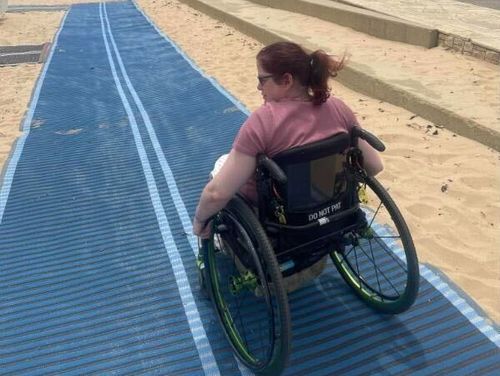 Beach matting allows people who use wheelchairs to reach the water's edge.