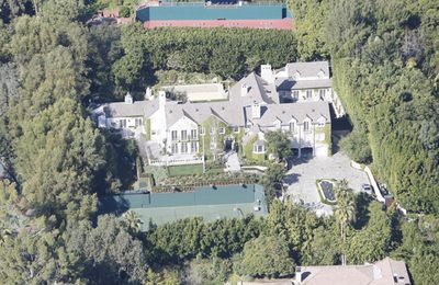 So <i>this</i> is where spoilt rotten celebrity kid,<B>Suri Cruise</b> spends her days. This aerial shot of <b>Tom Cruise</B> and <b>Katie Holmes</b>' mansion isn't bad, at least not for a five year old only child and her parents.  The house was originally built as a 10,000, yep, 10,000, square foot structure in 1937 but was <i>expanded</i> in 2003, four years before Tom and Katie snapped it up. The seven bedroom, nine bathroom home now sits on 1.3 acres behind tall gates and a long, long driveway. So how much did the place cost Katie and Tom? A whopping $35 million.