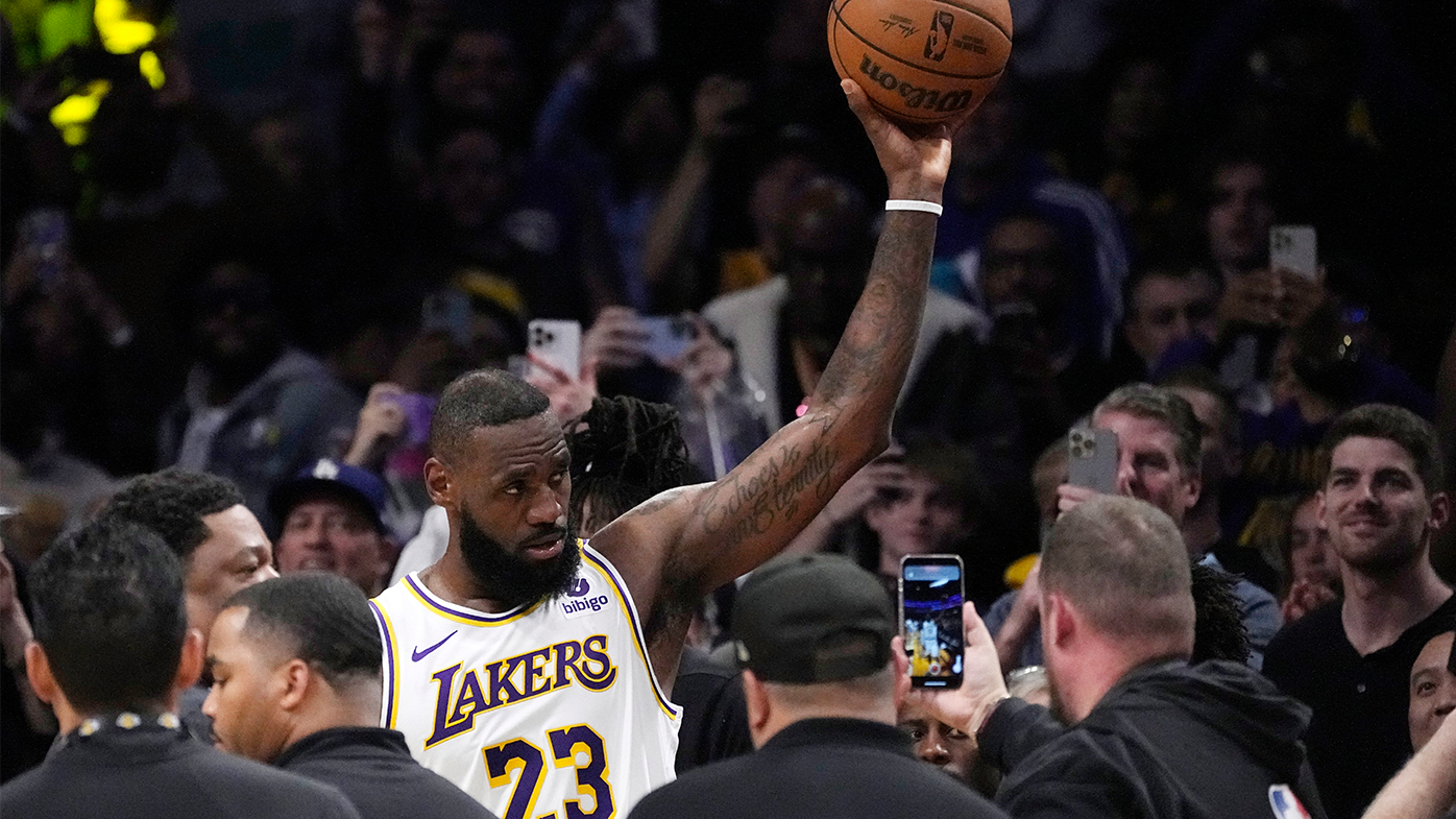 LeBron James acknowledges fans after becoming the first NBA player to reach 40,000 points in a career during the first half of the Lakers&#x27; match against the Nuggets.
