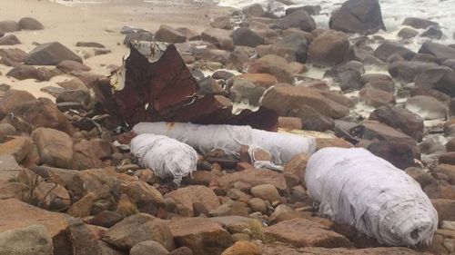 Shards of plastic and corrugated iron, reusable cups, rubbish, nappies and surgical masks have been seen washing up on beaches since the incident. Picture: Roads and Maritime Services.