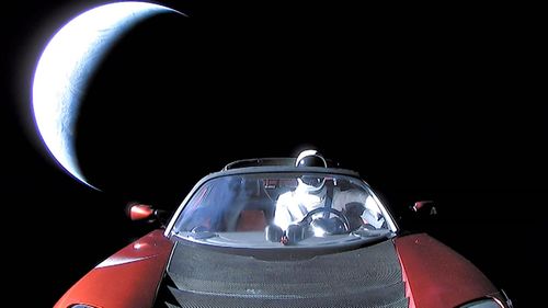 The spectacular final image of the Tesla in space and its mannequin 'driver'. (Photo: EPA).