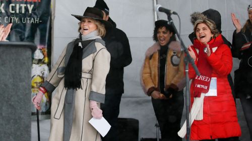 Attorney Gloria Allred, right, and actress Tessa Thompson, rear center, cheer for actress Jane Fonda, left, at the Respect Rally Park City during the 2018 Sundance Film Festival. (AP)